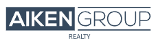 The image displays a logo consisting of the words "aiken group" in capitalized bold letters above the word "realty" in a smaller, capitalized font, with a horizontal line separating both phrases.